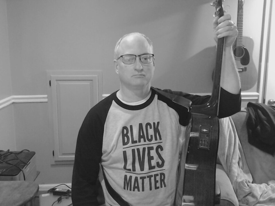 Dan in Black Lives Matter t-shirt, with guitar